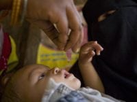 A health worker administers the oral polio vaccine during a door-to-door immunization campaign outside Lucknow, India. Find the story in "The Rotarian," December 2008, pages 28-43, and see Rotary Video Magazine 4.2.